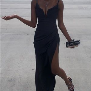 Black high slit heavy silk designer formal prom dress with a low v cut neck line